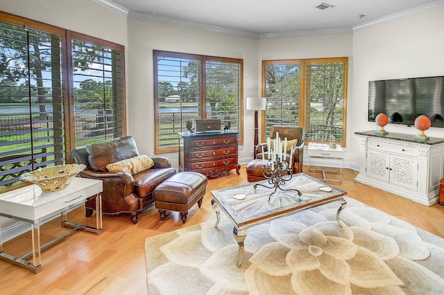 interior space with crown molding and light hardwood / wood-style flooring