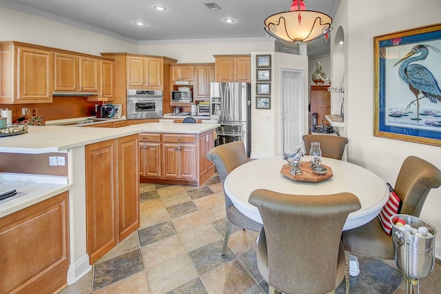 kitchen featuring crown molding, appliances with stainless steel finishes, a kitchen bar, and hanging light fixtures