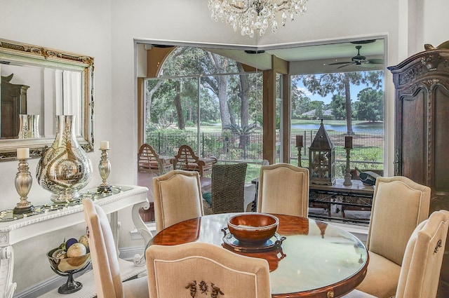 dining room with ceiling fan with notable chandelier