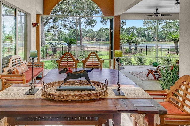 sunroom featuring plenty of natural light and ceiling fan