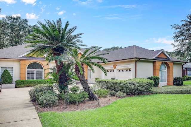 view of front of property featuring a garage and a front yard