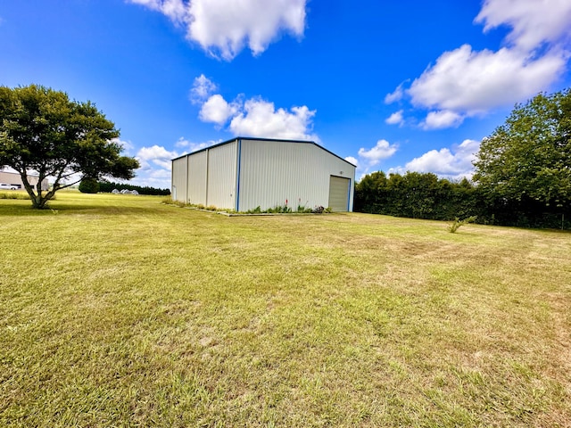 view of yard featuring an outbuilding and a garage