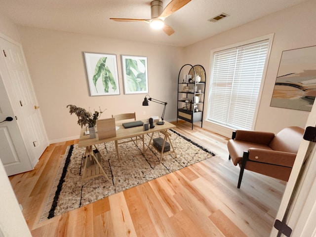 office area with light hardwood / wood-style flooring and ceiling fan