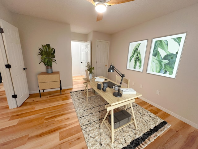 office space with wood-type flooring and ceiling fan