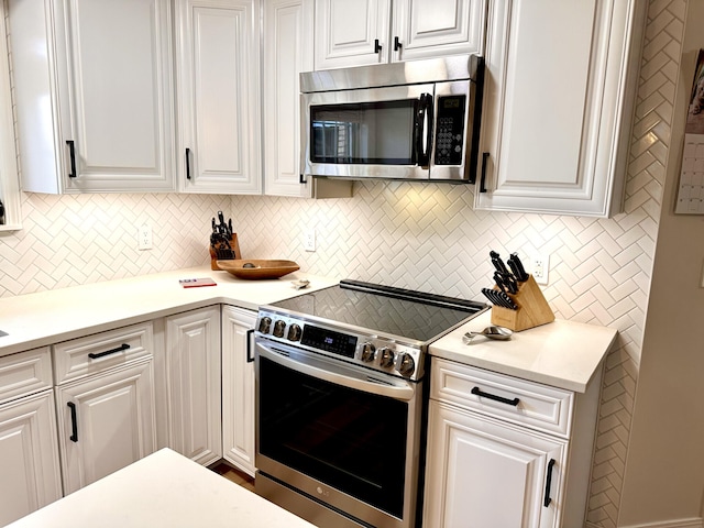 kitchen with white cabinets and appliances with stainless steel finishes