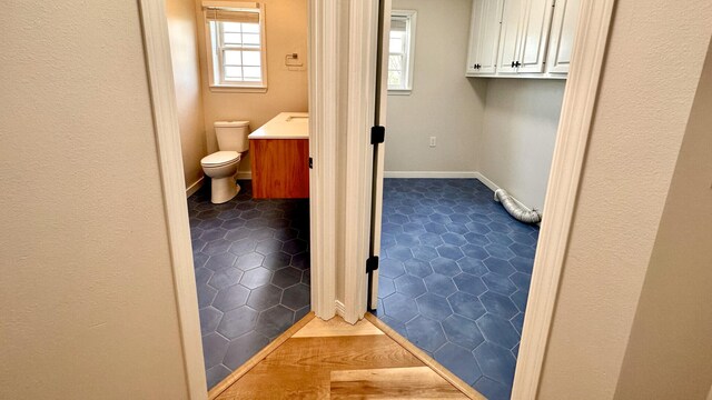 bathroom with vanity, tile patterned floors, and toilet