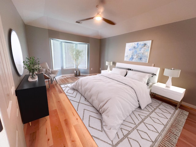 bedroom with hardwood / wood-style flooring and ceiling fan