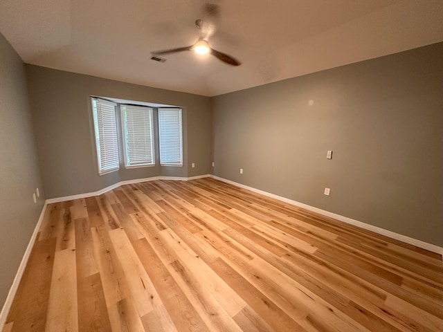 unfurnished room with ceiling fan and light hardwood / wood-style flooring