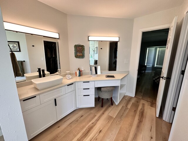 bathroom featuring hardwood / wood-style flooring and vanity