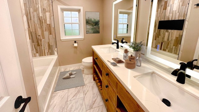 full bathroom with tiled shower / bath, vanity, and toilet