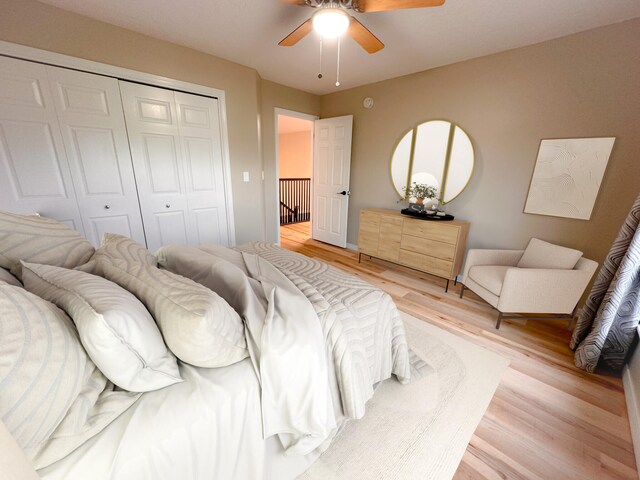 bedroom featuring ceiling fan, a closet, and light hardwood / wood-style flooring