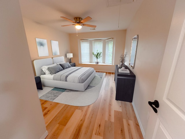 bedroom with wood-type flooring and ceiling fan