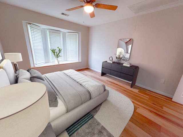 bedroom with light hardwood / wood-style floors and ceiling fan