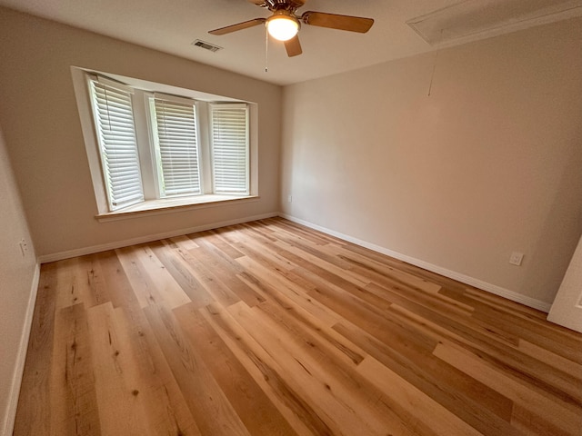 spare room featuring ceiling fan and light wood-type flooring