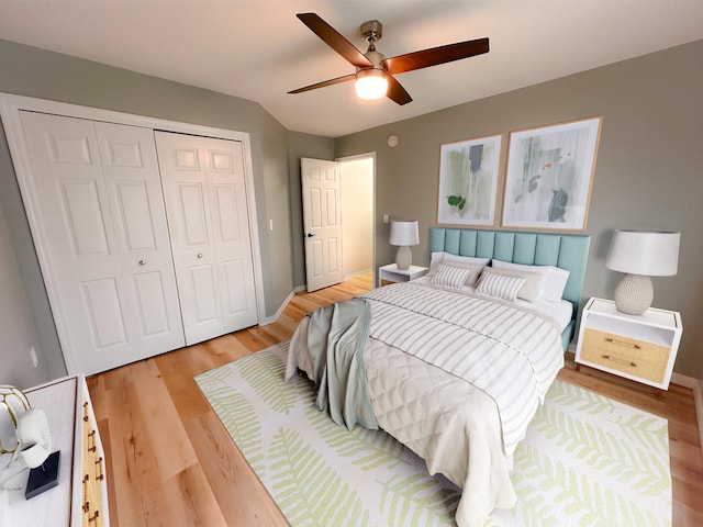 bedroom featuring hardwood / wood-style floors, ceiling fan, and a closet