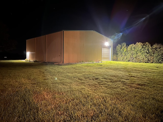 view of outbuilding featuring a yard