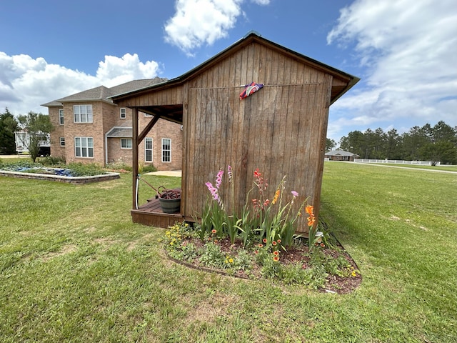 view of outdoor structure featuring a lawn