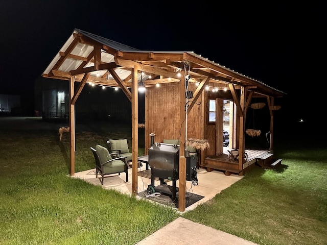 patio at twilight featuring a lawn