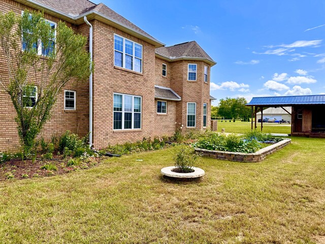 rear view of house featuring a yard