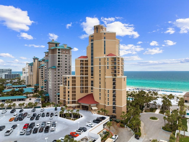 exterior space featuring a water view and a beach view