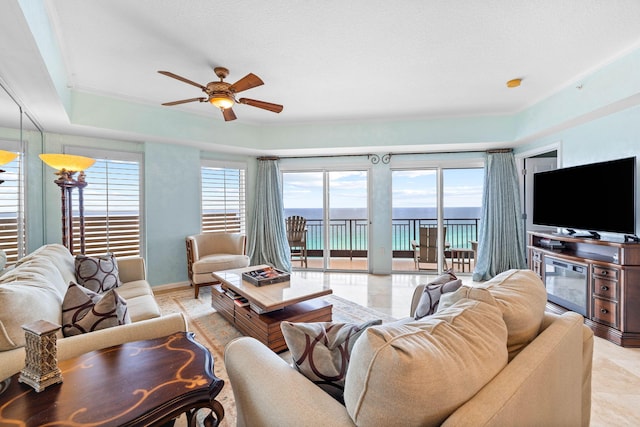 living room with a wealth of natural light and ceiling fan