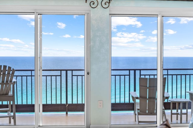 unfurnished sunroom with a water view