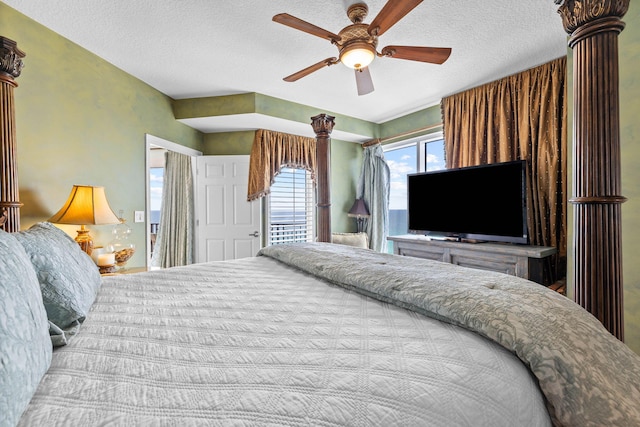 bedroom with ceiling fan and a textured ceiling