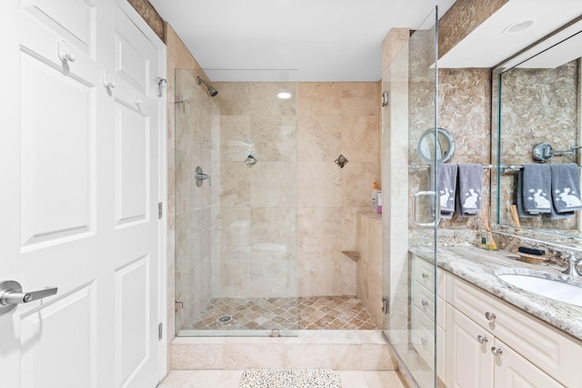 bathroom featuring vanity, tile patterned floors, and a shower with door