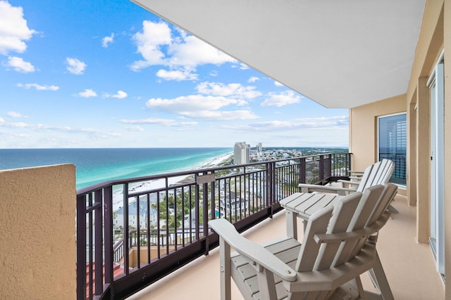 balcony featuring a water view and a view of the beach