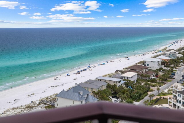 birds eye view of property featuring a water view and a beach view