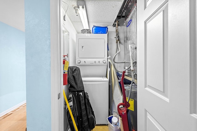 clothes washing area featuring stacked washer / drying machine