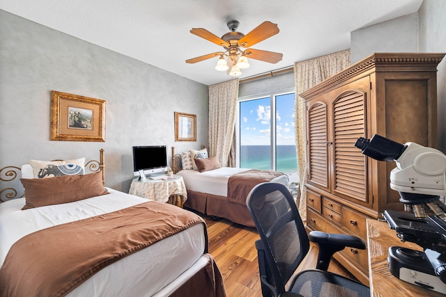 bedroom with ceiling fan, light wood-type flooring, and access to outside