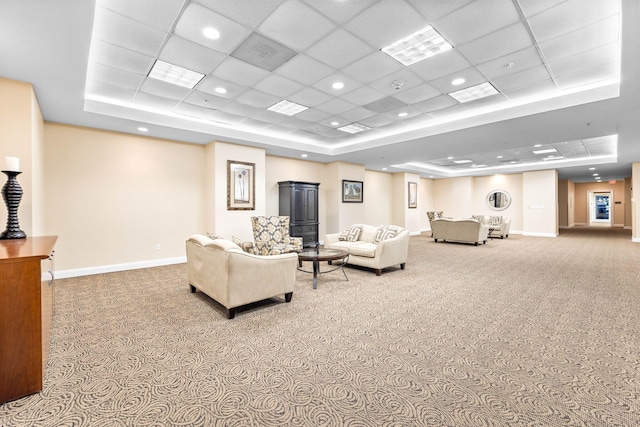 living room featuring a paneled ceiling, light colored carpet, and a tray ceiling