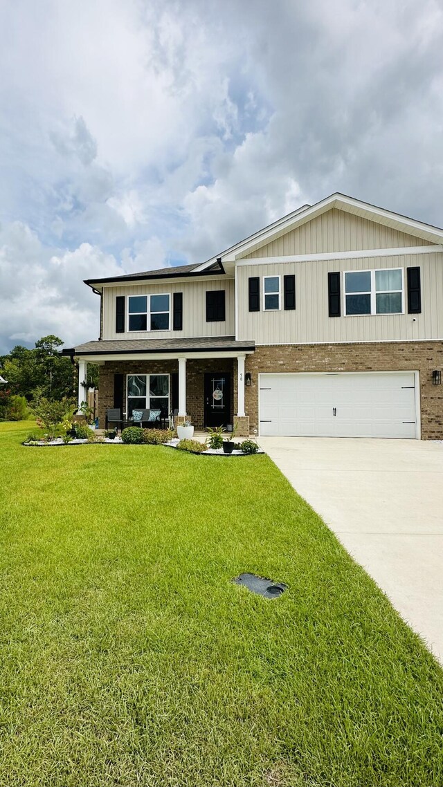 view of front of house with a garage and a front lawn