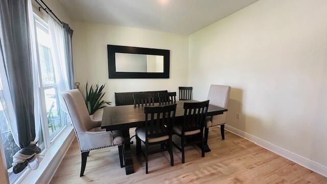 dining space with light wood-type flooring