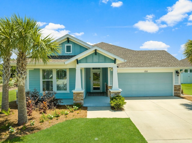 craftsman inspired home with a garage and a front yard