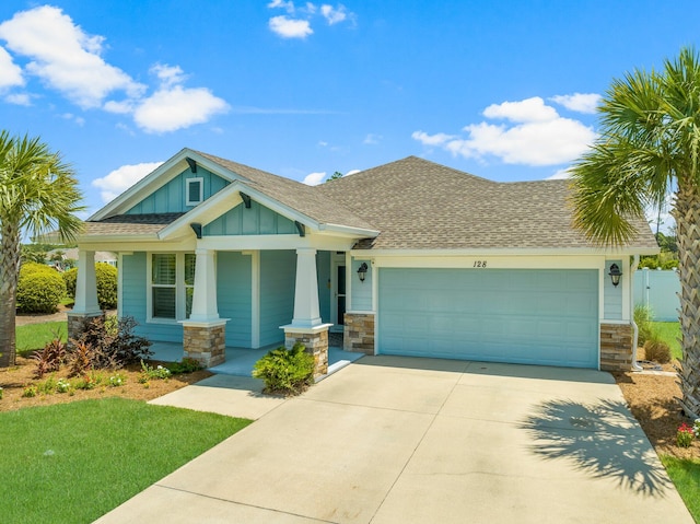 craftsman inspired home featuring a garage and covered porch