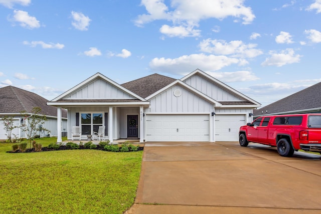 view of front of home featuring a garage, a front lawn, and a porch