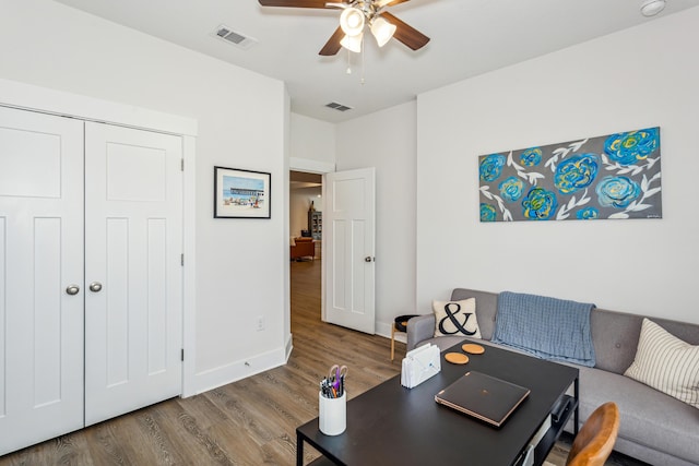 home office with hardwood / wood-style floors and ceiling fan