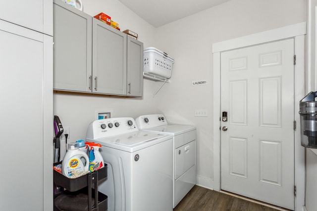 washroom with cabinets, washing machine and clothes dryer, and dark hardwood / wood-style flooring