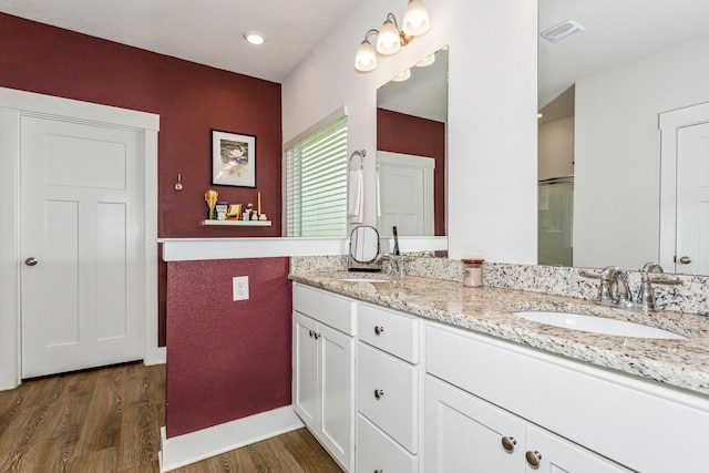 bathroom featuring hardwood / wood-style flooring and vanity