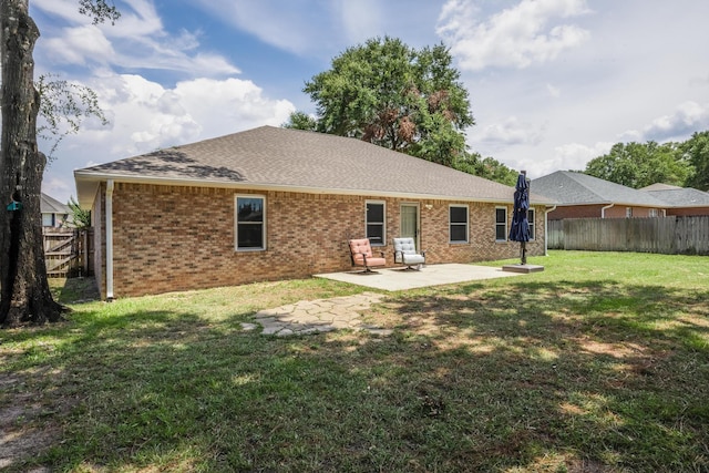 back of house featuring a yard and a patio