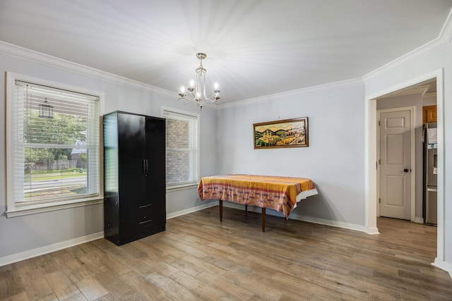 interior space featuring a notable chandelier, crown molding, and wood-type flooring