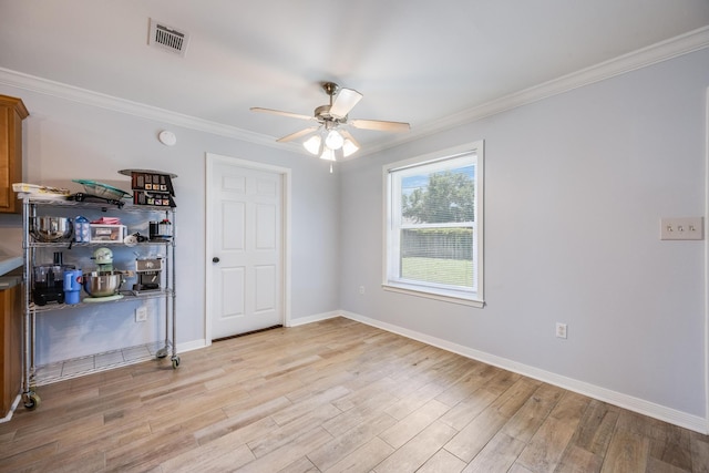 empty room featuring light wood-type flooring, ceiling fan, and ornamental molding