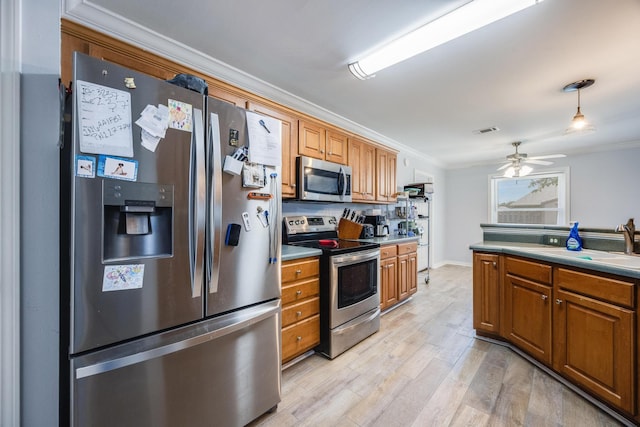 kitchen featuring appliances with stainless steel finishes, light hardwood / wood-style floors, hanging light fixtures, ceiling fan, and ornamental molding