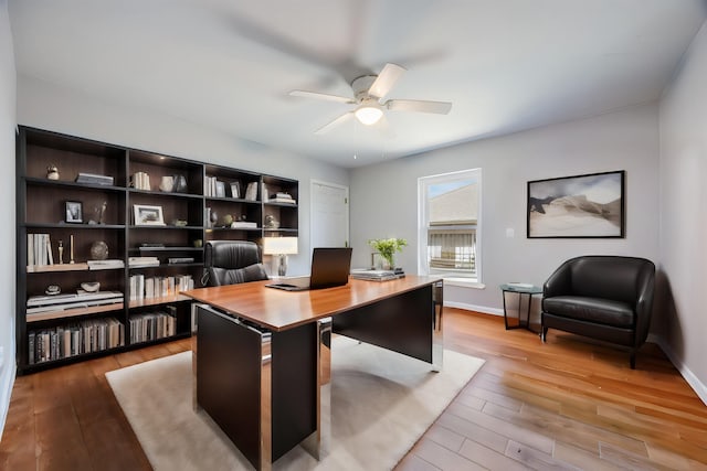 office featuring light hardwood / wood-style floors and ceiling fan