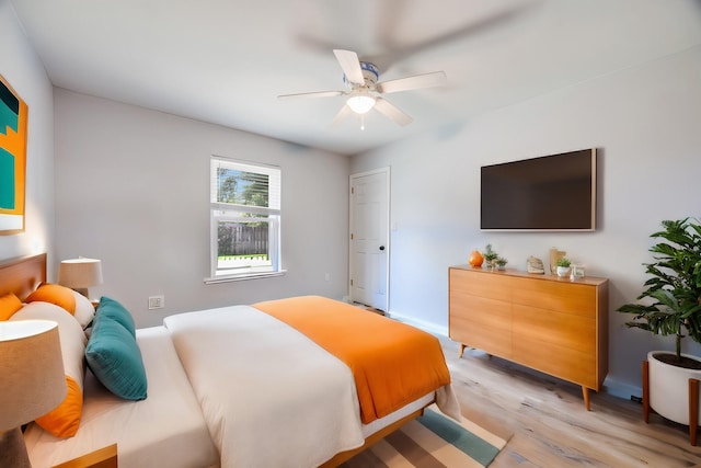 bedroom with ceiling fan and light hardwood / wood-style floors