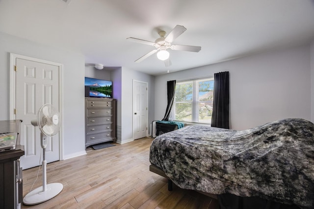 bedroom with ceiling fan and light wood-type flooring