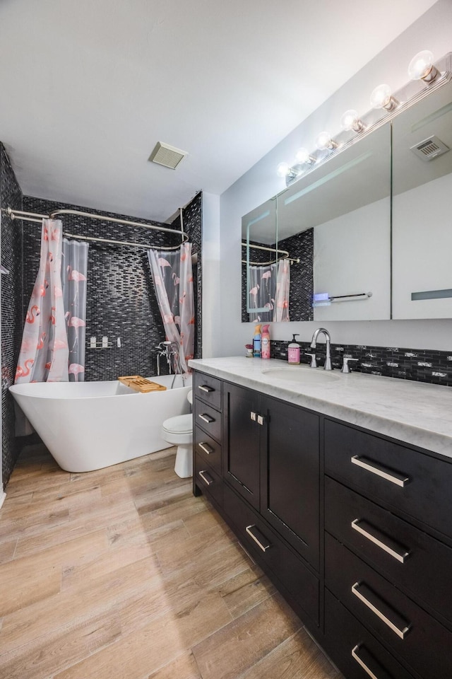 full bathroom featuring shower / tub combo, vanity, and toilet