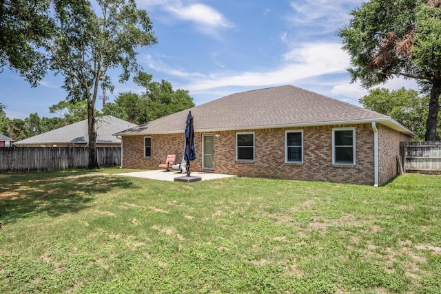 back of property with a patio and a lawn